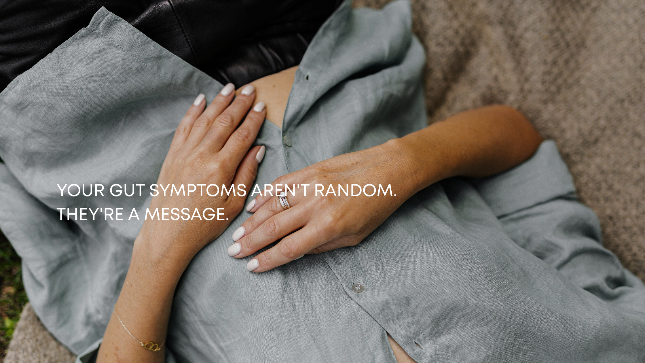 Woman with hands on abdomen experiencing digestive discomfort from chronic stress, Portland Oregon somatic medicine clinic